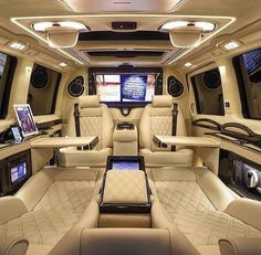 the interior of a luxury vehicle with all white leather seats and electronic devices on display