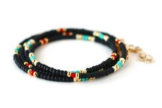 "Black, turquoise, red, white and gold beaded wrap style bracelet is 28\" long and will wrap around on average wrist (6.5-7\") four times. It comes with 1\" chain extender. It could be worn also as a necklace. Details: - Adjustable wrap style bracelet: 28\" long with 1\" chain extender, full length 29\" designed to fit 6.5-7\" wrists, - Listings include one bracelet - Bracelets may vary in exact pattern. Slight variations due to the individuality of each piece - This item should be kept away fro Black Round Beads Jewelry For Beach, Hand Wrapped Black Jewelry For Beach, Hand Wrapped Black Beach Jewelry, Black Spiritual Jewelry For The Beach, Spiritual Black Jewelry For The Beach, Spiritual Black Jewelry For Beach, Black Multi-strand Bohemian Bracelets, Bohemian Black Multi-strand Bracelets, Black Bohemian Beaded Bracelets With Spacer Beads