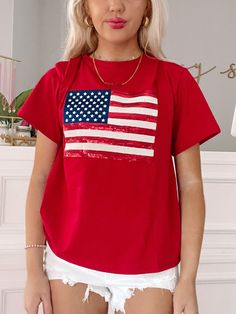 The White Born in the USA Tee from Sassy Shortcake is a white graphic tee with the American flag in red, white, and blue sequins. Also available in red and blue. Classic fit + unisex sizing. Model wearing a size small. Sassy Shortcake, Red Graphic Tee, Born In The Usa, Patriotic Dresses, Usa Tee, The American Flag, White Graphic Tee, Shoe Gifts, Red White And Blue