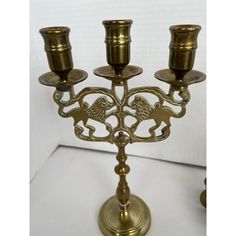 an ornate brass candelabra with four candles