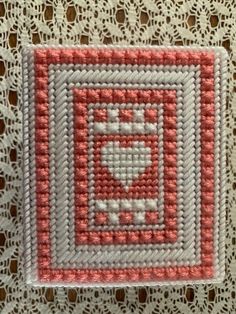 a close up of a piece of cloth with a heart in the center on a doily