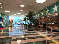 an airport lobby with checkered floor and stars painted on the walls