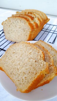 slices of bread sitting on top of a white plate next to a wire cooling rack