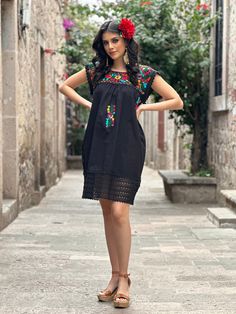 This Adorable Babydoll Dress is the perfect addition to your wardrobe. It's made out of fresh cotton or manta (as its called in  Spanish) and it is hand embroidered with cotton string.  The design is unique with lace details throughout and the colorful embroidery reflects the Rich Mexican culture! Note: Shoes and Jewelry modeled may be purchased here: Shoes: https://www.etsy.com/es/listing/828873953/zapato-artesanal-de-plataforma-zapato?ref=listings_manager_grid Filigrana Earrings: https://www.e Multicolor Cotton Embroidered Dress With Short Sleeves, Short Sleeve Cotton Embroidered Beach Dress, Embroidered Cotton Short Sleeve Beach Dress, Cotton Embroidered Short Sleeve Beach Dress, Short Sleeve Embroidered Cotton Dress For Beach, Short Sleeve Cotton Dress With Multicolor Embroidery, Folk Style Cotton Dress With Embroidered Hem, Casual Cotton Dress With Multicolor Embroidery, Cotton Dress With Embroidered Hem For Fiesta