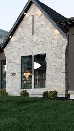 the front of a house with windows and grass