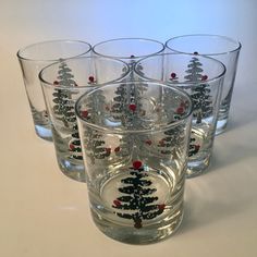 a set of six glasses with christmas trees on them