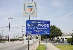 a welcome to inglewood city of champion sign on the side of the road