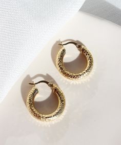 Textured Bold Hoop Earrings These stunning 14k gold hoop earrings with diamond cut pattern are prefect for everyday wear. They will add a precious touch to your daily outfits but also great for a night out look. They are definitely a must-have! Features: * These earrings are sold in pairs * They are made of patented 14k solid gold. * Size: 2,3 cm Packaging: You will get your jewelry in a beautiful pink Pharos Jewellery box. This box will protect your precious item during the shipping process. It Luxury Small Hoop Earrings As Gift, Gold Small Hoop Earrings For Everyday Luxury, Everyday Luxury Gold Hoop Huggie Earrings, Fine Jewelry Small Hoop Earrings With Diamond Cut, Small Hoop Diamond Cut Earrings, Luxury Small Hoop Earrings For Everyday, Diamond Cut Gold Plated Huggie Earrings, Diamond Cut Huggie Gold Plated Hoop Earrings, Luxury Small Hoop Pierced Earrings