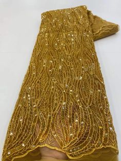 This high quality Fabric is measured in 5 Yards With Embroidered Beading and Sequin. It is soft, very delicate and beautiful. This high Quality Fabric is made with Fashion embroidered rhinestones can be used in making party wedding dresses, skirts, shawls, scarves and other other fashion apparels as you would like. Size : Length : 5 yards (180 inch). Width: 50 inch (Please allow slight deviation for the measurement data ,±1 inch) Material: 100% Polyester, Tulle Lace Fabric, Eco-Friendly embroide Embroidered Gold Fabric And Notions For Party, Embroidered Gold Fabric For Party, Gold Embroidered Fabric With Rhinestones For Party, Yellow Embellished Embroidered Fabric For Party, Gold Embroidered Fabric With Rhinestones For Wedding, Gold Embroidered Fabric With Sequins, Elegant Embellished Gold Sequin Fabric, Fitted Gold Embroidered Beaded Fabric, Gold Lace Fabric With Sequins Embroidery