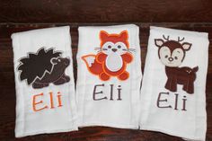 three hand towels with embroidered animals on them