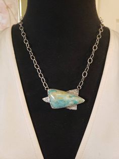 "A beautiful, natural, UNTREATED stone - PERUVIAN OPAL! Beautiful blue-ish green color The freeform Trillion Cabachon measures 45x23mm; the overall pendant measures 2\" across, and 1\" top to bottom. It is bezel set with a scalloped edge, and completely handcrafted. We attached it to an open cable link chain, with a lobster claw clasp. It can be attached at any length, up to a maximum of 20\". Hallmarked 925 Contact me with any questions" Green Chrysocolla Necklace With Large Pendant, Silver Chrysocolla Necklace With Large Stone, Unique Green Chrysocolla Necklaces, Artisan Green Necklace With Large Stone, Nature-inspired Green Necklace With Large Pendant, Nature-inspired Green Necklaces With Large Stone, Nature-inspired Green Necklace With Large Stone, Petrified Wood Jewelry, Homemade Pendant