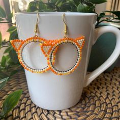 As someone with two orange cats, I can confirm that they are, in fact, like that. Handmade beaded frame earrings featuring Toho seed beads and other various beads. Made with a combination of Fireline and Nymo beading thread, these earrings are sturdy and secure. Made on the traditional and unceded territories of the Qayqayt First Nation, and other Halq'eméylem speaking peoples. Orange Beaded Hoop Earrings As A Gift, Orange Beaded Hoop Earrings For Gift, Orange Hoop Beaded Earrings As Gift, Handmade Orange Hoop Earrings, Orange Beaded Hoop Earrings, Orange Hoop Earrings With Colorful Beads For Gift, Frame Earrings, Beaded Frame, Beading Thread