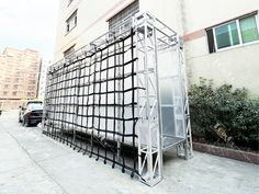 a large metal structure sitting on the side of a building