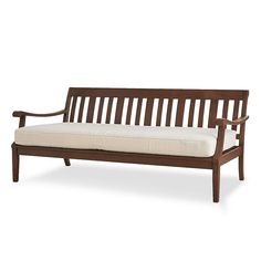 a wooden bench with white cushions on it