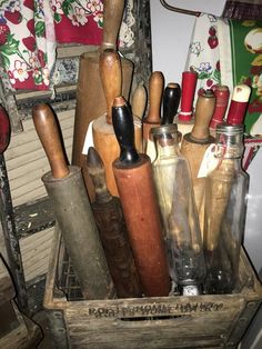 an old wooden box filled with different types of kitchen utensils