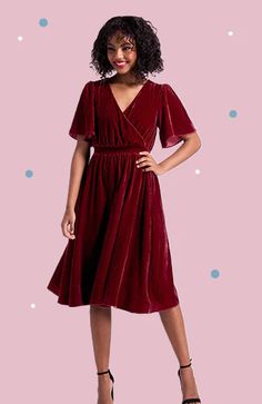 In a rich, beetroot red hue, this fluttery and flow-y velvet midi dress makes crossing the room look like a beautiful dance. Made from a stretchy velvet fabric with a gorgeous sheen and a plush texture, this effortlessly elegant midi dress boasts short flutter sleeves, a surplice neckline, and a gathered high-rise waistline that gives way to a drapey and dreamy A-line skirt. 40s Dresses, 50 Dress, Purple Wrap Dress, 1940s Fashion Dresses, Beautiful Dance, Elegant Midi Dress, Fashion 70s, Valentines Day Dresses, Elegant Midi Dresses