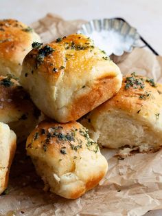 several pieces of bread sitting on top of wax paper