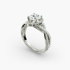 a white gold engagement ring with an oval center stone and twisted shants on the side