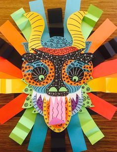 a paper mask made to look like an animal's head with colorful strips on it