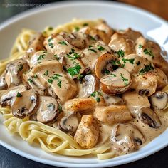 a white plate topped with pasta covered in mushrooms