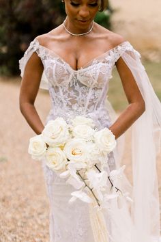 a woman in a wedding dress holding a bouquet