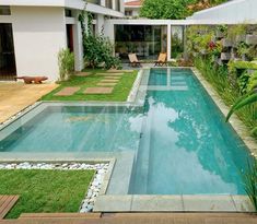 an empty swimming pool in the middle of a garden