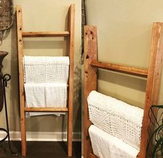 two wooden ladders with white towels on them next to each other in a room