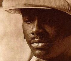 a black and white photo of a man wearing a hat