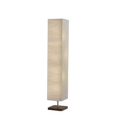 a tall lamp with a white shade on it's side and a wooden base