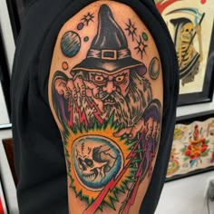 a man with a wizard hat and eye patch on his arm