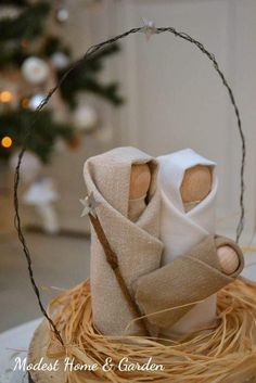 an ornament made to look like two cloth dolls in a nest