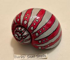 a small red and white snail on a table