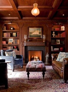 a living room filled with furniture and a fire place in the middle of a room