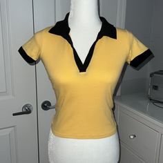 - One Size (Fits Like A Xs/S) - Mustard Yellow With Black Around The Collar And Sleeves - Never Worn Before - Brand New Without Tags! Yellow Stretch Y2k Top, Stretch Yellow Y2k Tops, Yellow Fitted Trendy Top, Yellow Fitted Y2k Top, Fitted Yellow Y2k Tops, Fitted Trendy Yellow Top, Trendy Fitted Yellow Top, Fitted Yellow Cotton Top, Yellow Fitted Vintage Tops