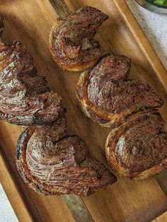 several pastries are on a wooden cutting board