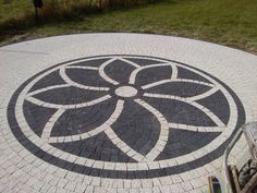 a black and white circular design on the ground