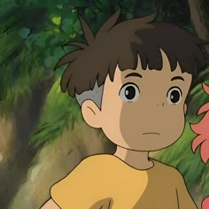 a young boy standing next to a pink bird in a forest with lots of trees