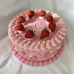 a pink cake with strawberries on top