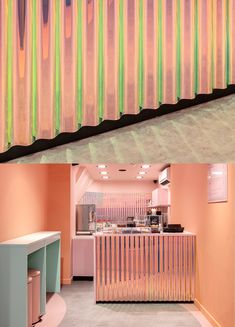 the inside of a restaurant with pink walls and green bars on the outside wall, and an open counter area in front of it