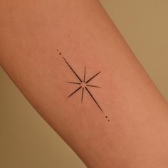 a small star tattoo on the right arm and leg, with dots around it in black ink