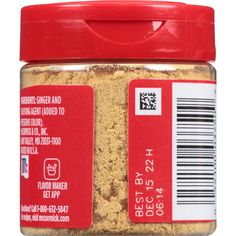 a jar of food that is on a white surface with a red lid and label