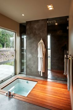 a bath room with a jacuzzi tub and a window