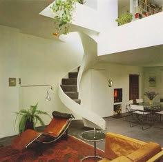 a living room filled with furniture and a spiral staircase