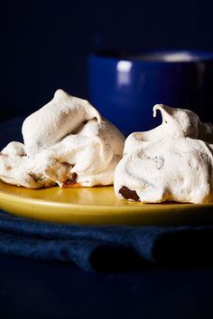 two pieces of meringue on a yellow plate