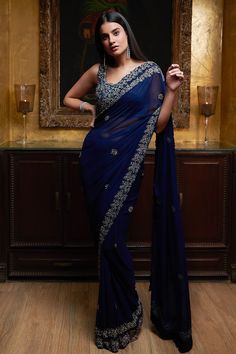 Midnight blue saree highlighted with antique zardozi embroidery and cutwork hem. Come with square neckline blouse.
Components:2
Embroidered
Neckline:Square
Sleeve Length:Sleeveless
Fabric:Georgette
Color:Blue
Embroidered blouse with cutwork hem
Low back neck with tie-up - Aza Fashions Dark Blue Half Saree, Midnight Blue Saree, Sari Farewell, Blouse For Blue Saree, Simple Sarees Classy, Blue Saree Blouse Designs, Royal Blue Saree Look, Simple Saree Look Classy, Saree Styles Modern Classy