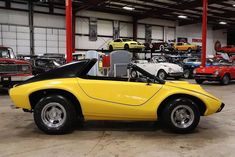 a yellow sports car parked in a garage