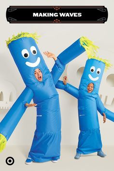 two people in blue costumes with arms and legs made to look like they are dancing