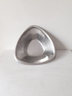 a metal object sitting on top of a white table