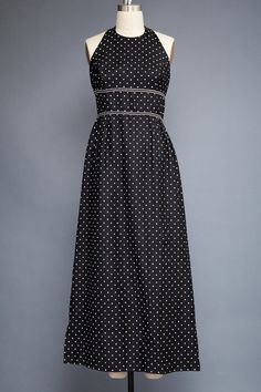 ♦ vintage 70s maxi dress ♦ halter with hooks + eyes strap at back of neck ♦ black with white polka dot ♦ empire double waist band and gathered skirt ♦ back nylon zipper, unlined    ----- Measurements (taken flat across garment)  Bust : 37 Waist : 28 Hips : 47 Length: 55 Sleeve length: - Tag: - Note Fitted Halter Neck Lined Maxi Dress, Fitted Polka Dot Maxi Dress, Chic Fitted Maxi Dress With Empire Waist, Summer Black Maxi Dress With Fitted Bodice, Fitted Polka Dot Dress For Daywear, Summer Evening Polka Dot Maxi Dress, Polka Dot Maxi Dress For Summer Evenings, Fitted Polka Dot Maxi Dress For Spring, Spring Black Maxi Dress With Fitted Bodice