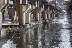 the water is running under the concrete structures in the area where there are no people